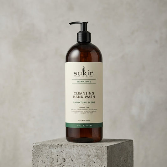 Sukin cleansing hand wash bottle on a concrete block with a neutral background