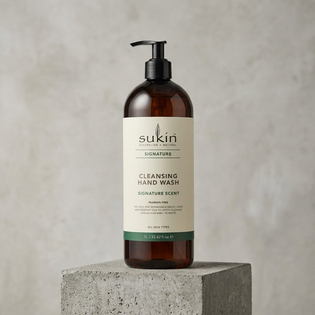 Sukin cleansing hand wash bottle on a concrete block with a neutral background
